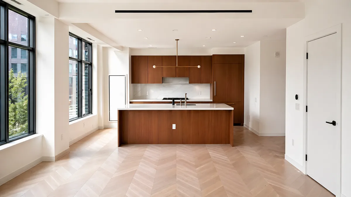 An open-concept Bronx kitchen with wood cabinetry, an island and herringbone floors