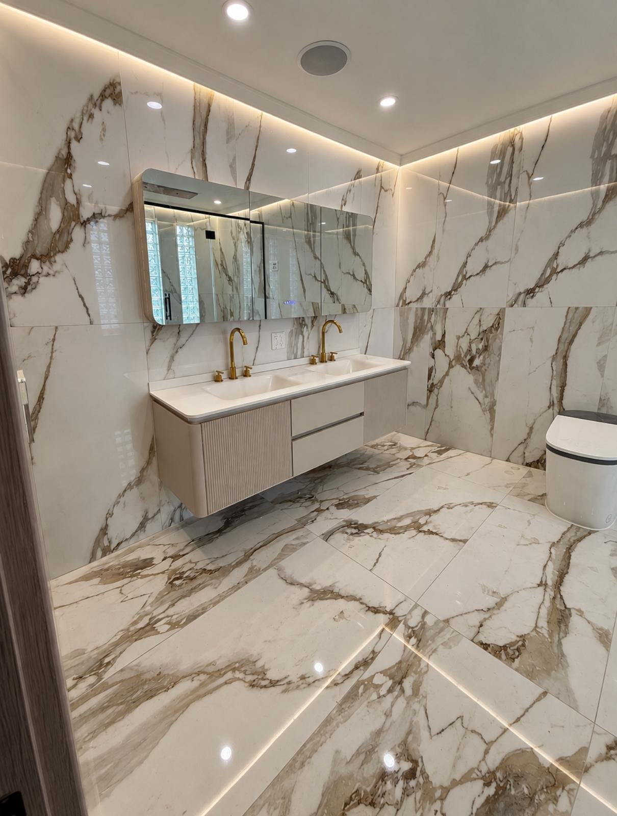 Queens primary bathroom with Calacatta porcelain tile and a fluted double floating vanity
